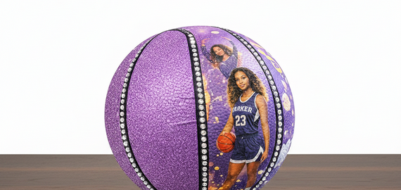 Purple basketball with a player's image on a wooden surface