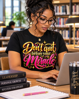 Girl sitting at laptop wearing black shirt