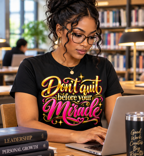 Girl sitting at laptop wearing black shirt
