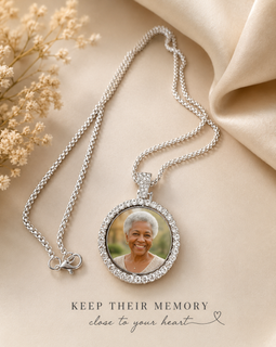 Silver necklace with a photo pendant on a beige fabric background