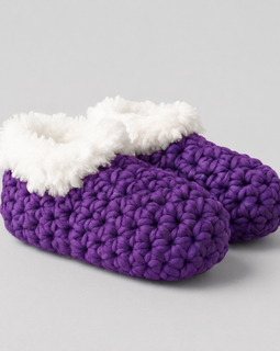 Purple crochet slippers with white fur lining on a gray background